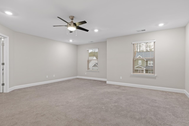 spare room with light carpet and ceiling fan