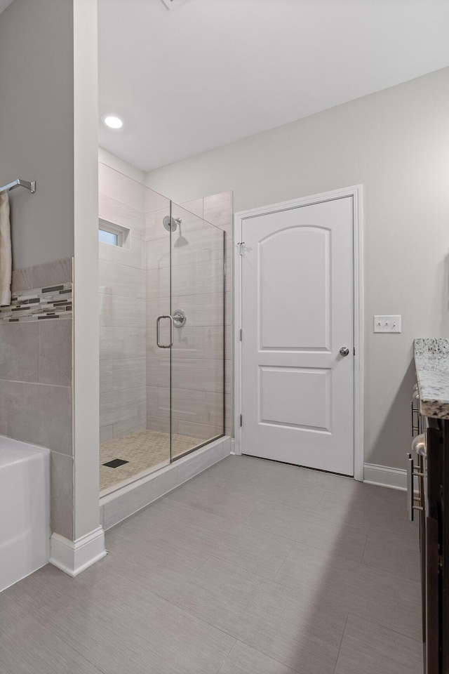 bathroom with vanity and separate shower and tub