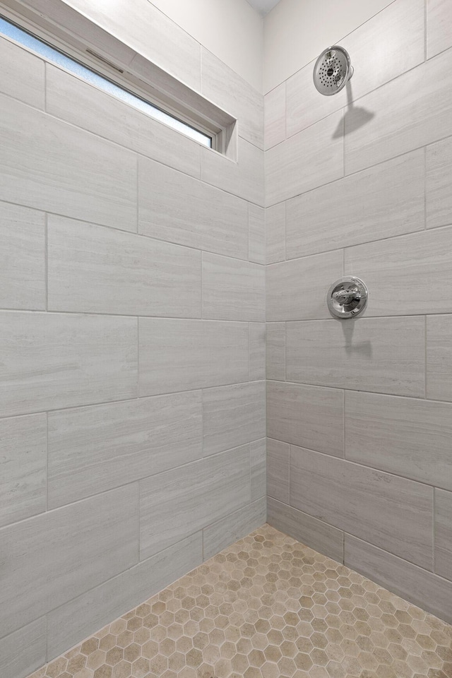 bathroom with tiled shower