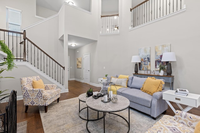 living room with hardwood / wood-style flooring and a high ceiling