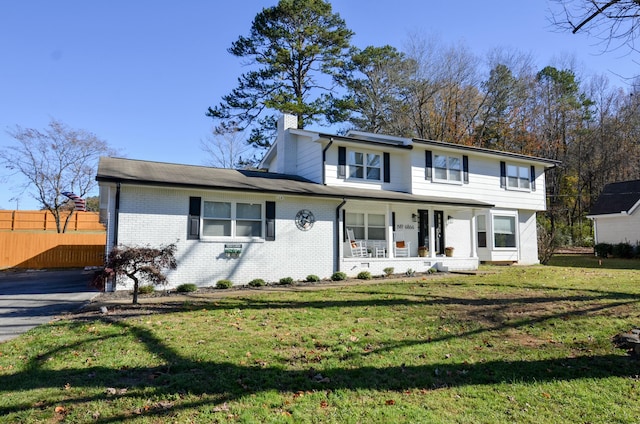 view of front facade with a front lawn and a porch