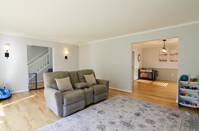 living room with ornamental molding and light wood-type flooring