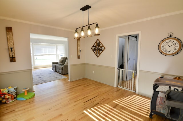 dining room featuring light wood-type flooring and ornamental molding