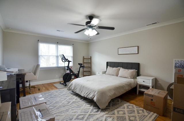 bedroom with ceiling fan, hardwood / wood-style floors, and ornamental molding