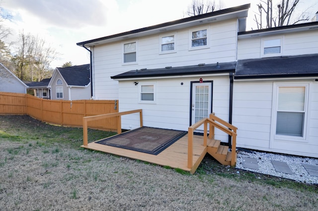 rear view of house featuring a lawn