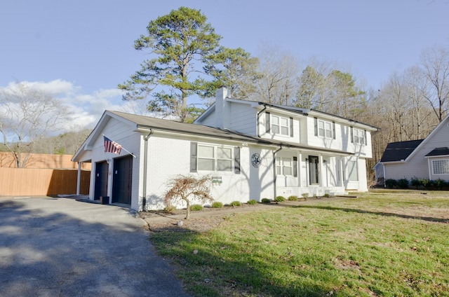 view of front of home with a garage, covered porch, and a front yard