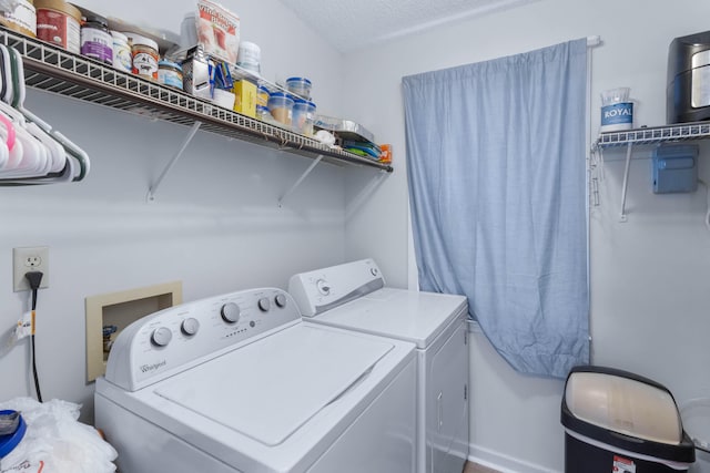 laundry area with a textured ceiling and independent washer and dryer