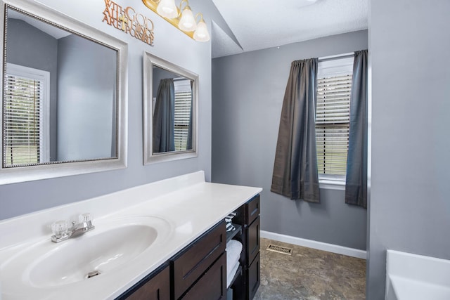 bathroom with vanity and a textured ceiling