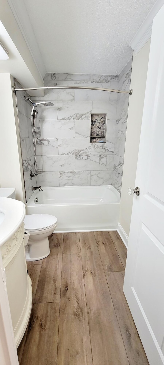 full bathroom featuring toilet, vanity, tiled shower / bath combo, and hardwood / wood-style flooring