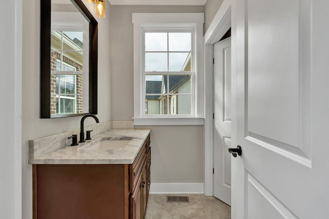 bathroom with tile patterned floors, plenty of natural light, and vanity