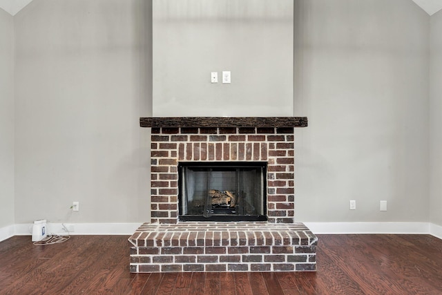 room details with hardwood / wood-style flooring and a brick fireplace