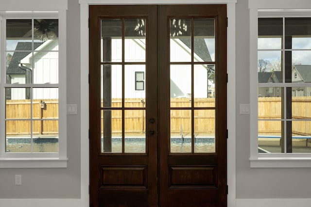 doorway to outside featuring french doors and a healthy amount of sunlight