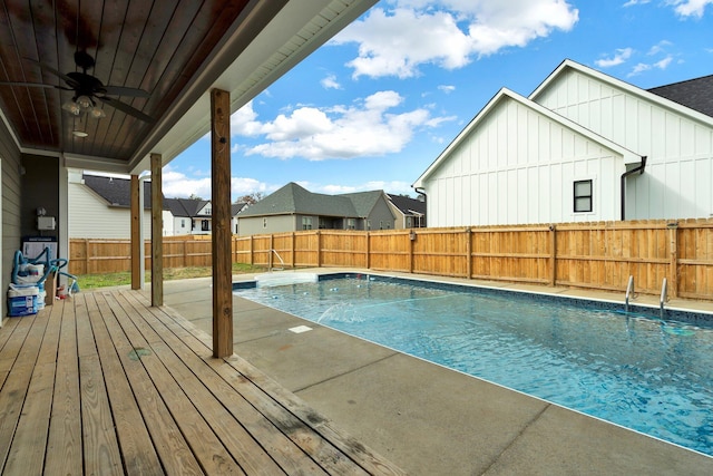 view of pool featuring ceiling fan and a wooden deck