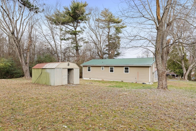 back of property with a storage shed and a lawn