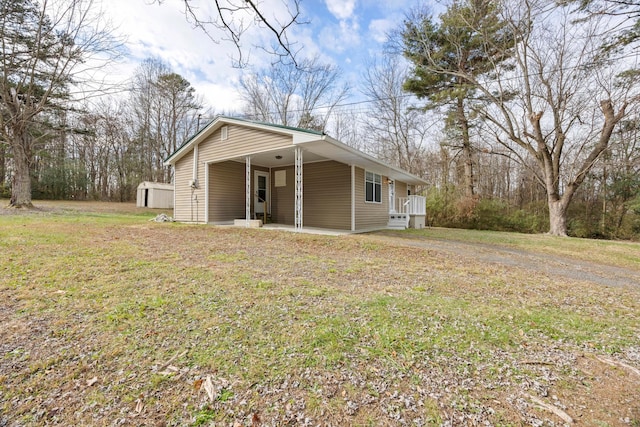 exterior space featuring a lawn and a shed