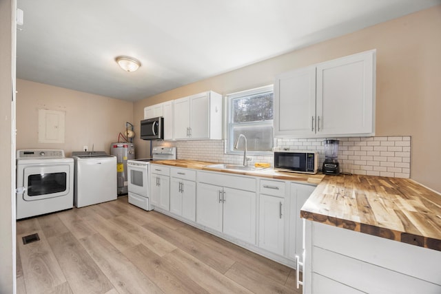 kitchen with electric water heater, white cabinets, independent washer and dryer, white range with electric cooktop, and butcher block counters