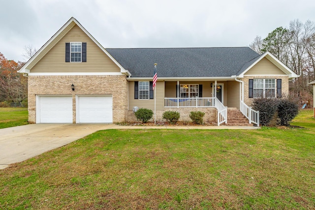 view of front of property featuring a porch, a garage, and a front lawn