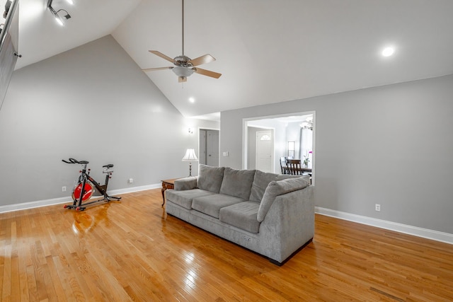 living room with hardwood / wood-style floors, high vaulted ceiling, and ceiling fan