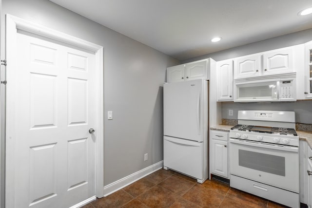 kitchen featuring white appliances and white cabinets