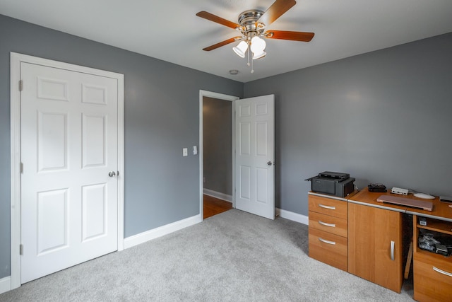 office with ceiling fan and light carpet