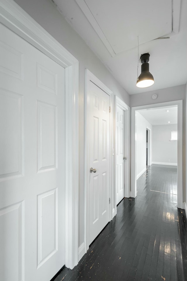 hallway with dark hardwood / wood-style floors