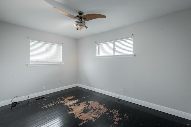 empty room featuring ceiling fan and dark hardwood / wood-style flooring