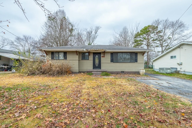 single story home with central air condition unit and a front yard