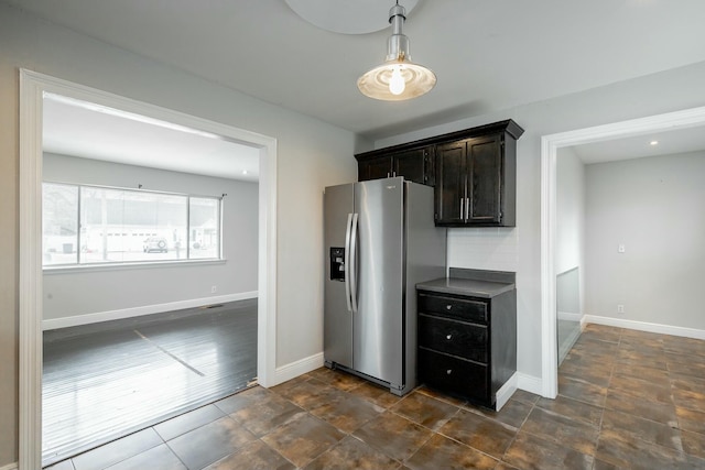 kitchen with stainless steel fridge and dark brown cabinetry