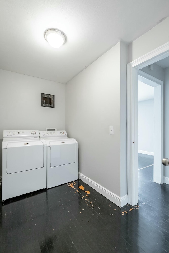 laundry room featuring dark hardwood / wood-style floors and washer and dryer