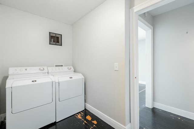 clothes washing area with washer and dryer and dark hardwood / wood-style floors