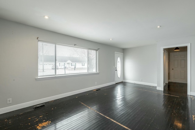 empty room featuring dark hardwood / wood-style flooring