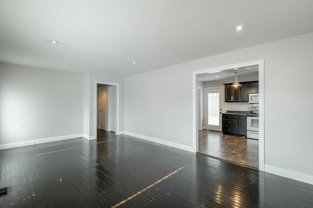 spare room featuring dark wood-type flooring