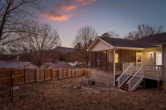 exterior space featuring a sunroom and a mountain view