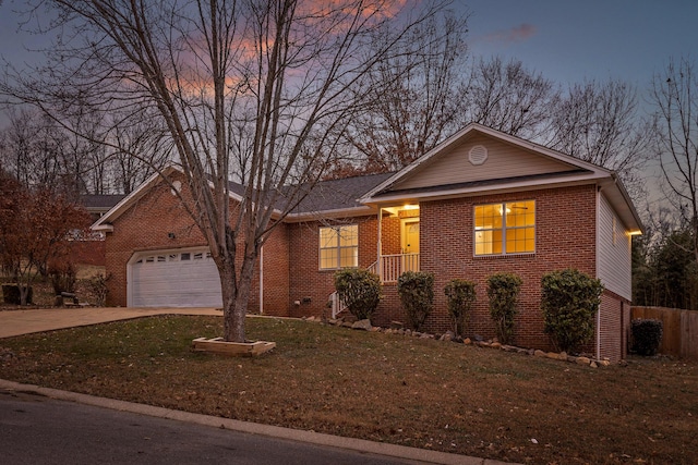 ranch-style home featuring a yard and a garage