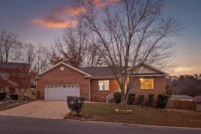 ranch-style home with a yard and a garage