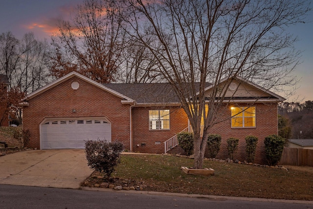 single story home with a lawn and a garage