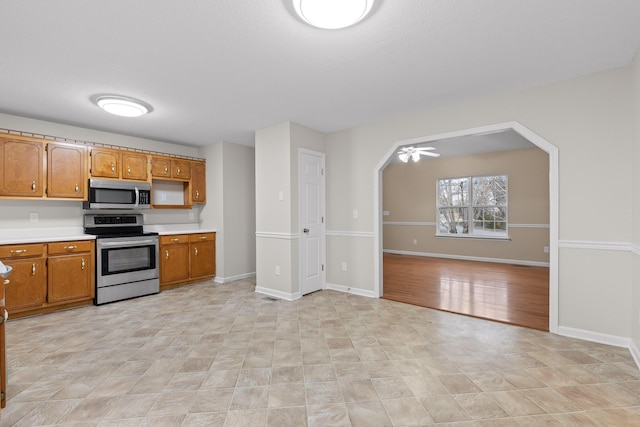 kitchen with ceiling fan and appliances with stainless steel finishes