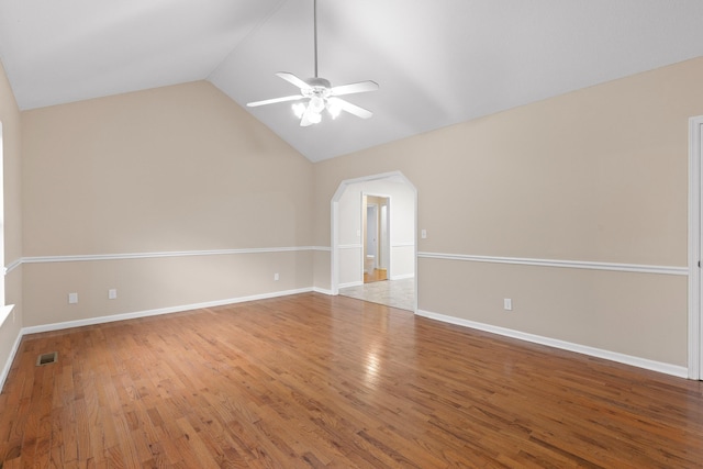 empty room featuring ceiling fan, lofted ceiling, and hardwood / wood-style flooring