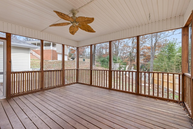 unfurnished sunroom featuring ceiling fan