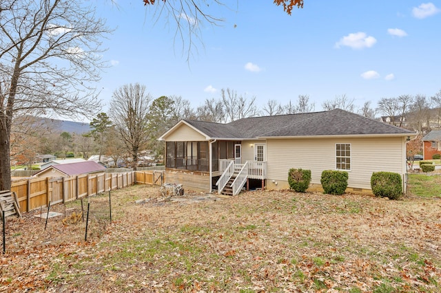 back of property with a sunroom and a mountain view