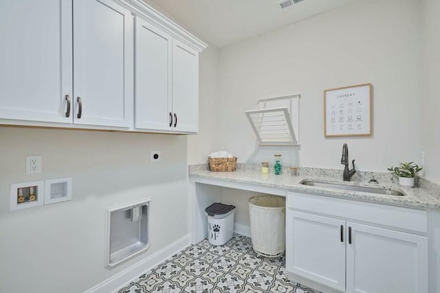 clothes washing area featuring cabinets, washer hookup, hookup for an electric dryer, sink, and light tile patterned flooring