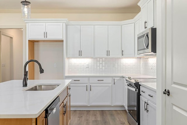 1707 Whisper Winds Ln Unit 33, Ooltewah, TN 37363 - kitchen featuring stainless steel appliances, white cabinetry, tasteful backsplash, light wood-type flooring, and crown molding