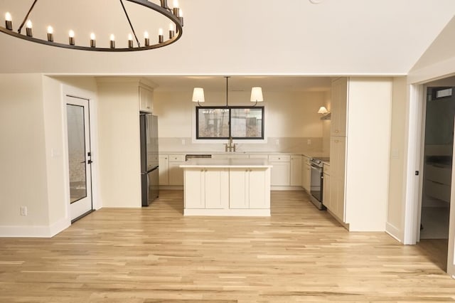 kitchen featuring white cabinetry, light hardwood / wood-style floors, stainless steel appliances, and a center island