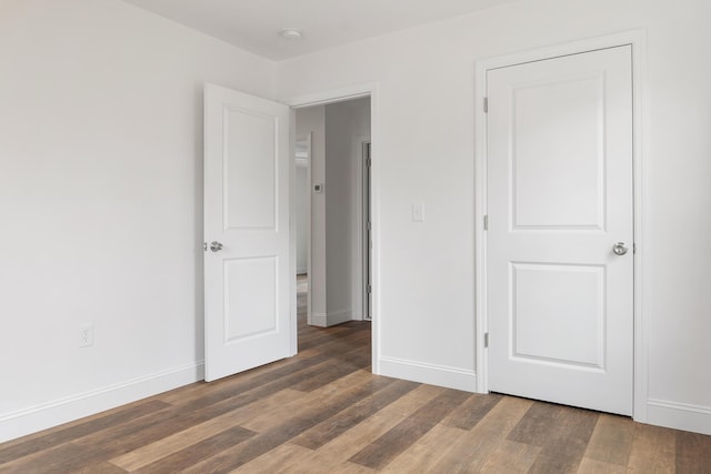 unfurnished bedroom featuring dark wood-type flooring