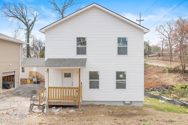 rear view of property featuring a garage