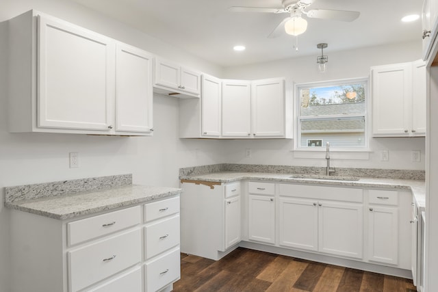 kitchen with dark hardwood / wood-style flooring, ceiling fan, sink, and white cabinets