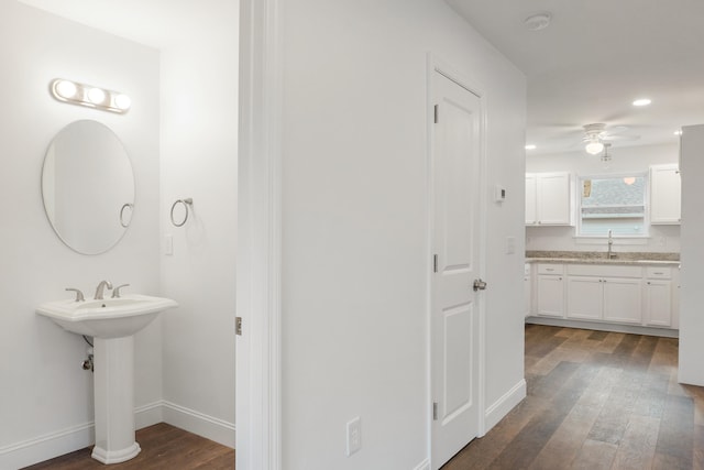 bathroom with ceiling fan and hardwood / wood-style flooring