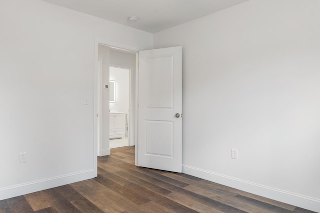 spare room featuring dark wood-type flooring