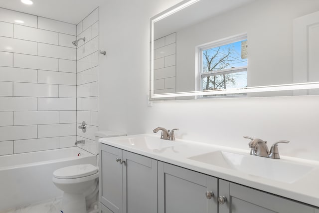 full bathroom with vanity, toilet, and tiled shower / bath combo