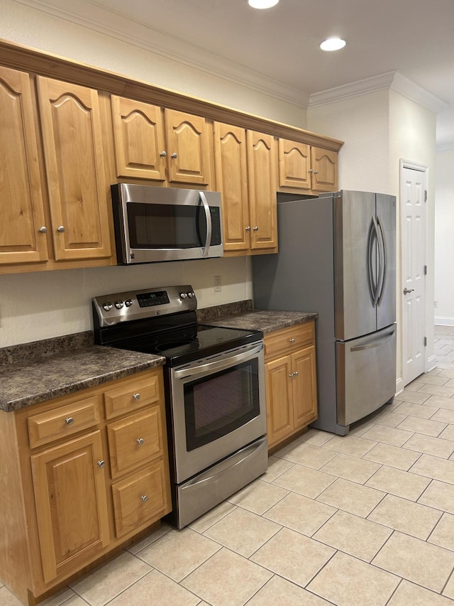 kitchen featuring dark stone countertops, crown molding, and appliances with stainless steel finishes